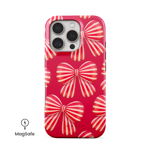 Bow Chic MagSafe phone case featuring bold, eye-catching red-striped bows on a vibrant red backdrop, front view on iPhone