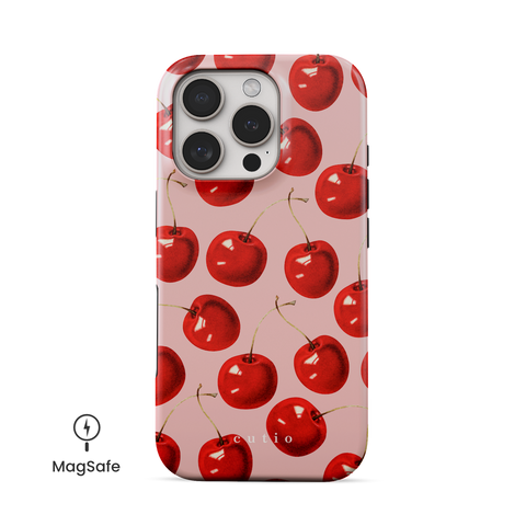 Cherry On Top MagSafe phone case featuring luscious red cherries on salmon pink background, front view on iPhone