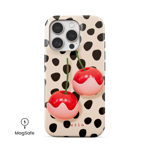Choco Cherries MagSafe phone case featuring charming 3D-look white chocolate-covered red cherries set against black dots pattern on a soft beige background, front view on iPhone