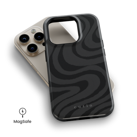 Desert Night MagSafe phone case featuring mysterious dark grey swirls pattern on black background, resembling desert sand under the night sky, top down view on iPhone