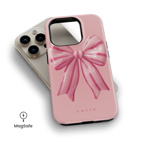 Eye Candy MagSafe phone case featuring adorable 3D striped pink bow design, top down view on iPhone