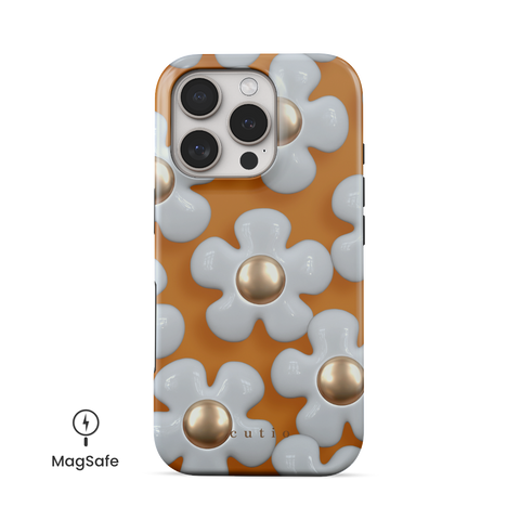 Flower Charm MagSafe phone case featuring elegant 3D metallic white daisies on a warm mustard yellow background, front view on iPhone