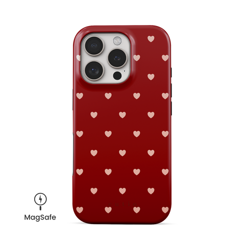 Full Of Hearts MagSafe phone case featuring cute and playful pink hearts pattern on bold red background, front view on iPhone
