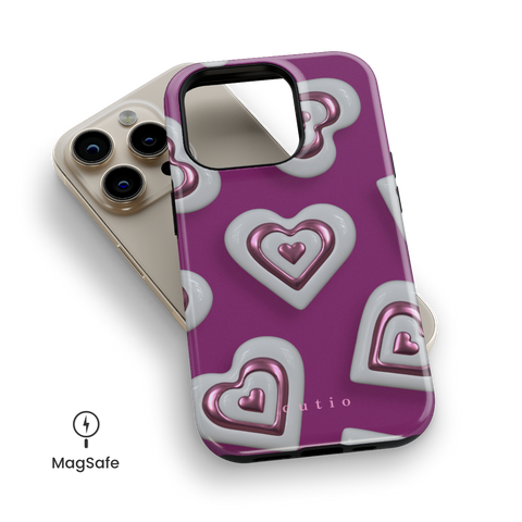 Heart Charm MagSafe phone case featuring vibrant 3D metallic pink hearts on a bold magenta pink background, top down view on iPhone