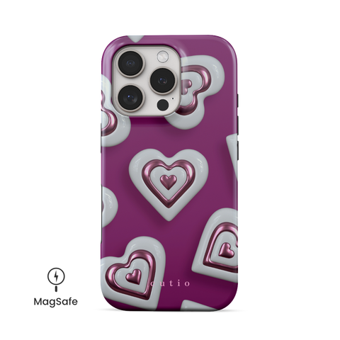 Heart Charm MagSafe phone case featuring vibrant 3D metallic pink hearts on a bold magenta pink background, front view on iPhone