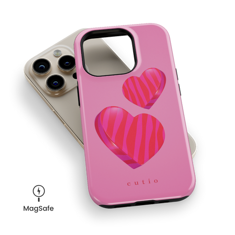 Lovestruck MagSafe phone case featuring adorable 3D-look hot pink hearts set against a soft pink gradient background, top down view on iPhone