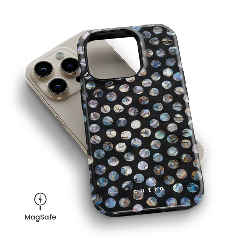 Ocean Hue MagSafe phone case featuring organic-shaped polka dots in intricate iridescent oyster shell hues on black background, top down view on iPhone
