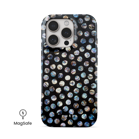 Ocean Hue MagSafe phone case featuring organic-shaped polka dots in intricate iridescent oyster shell hues on black background, front view on iPhone