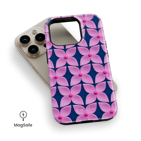 Pink Hydrangea MagSafe phone case featuring abstract glossy pink hydrangea flower pattern with hot pink centers on a deep navy blue background, top down view on iPhone