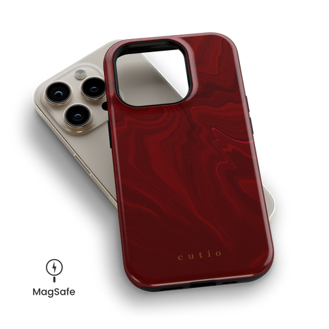 Red Lipstick MagSafe phone case featuring vibrant red swirls pattern, top down view on iPhone