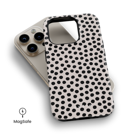 Spotted MagSafe phone case featuring classic organic-shaped polka dots on beige background, top down view on iPhone
