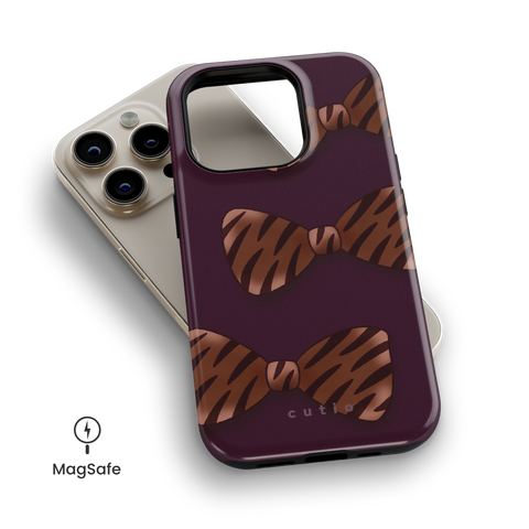Tiger Bows MagSafe phone case featuring bold tiger-print bows on dark purple background, top down view on iPhone