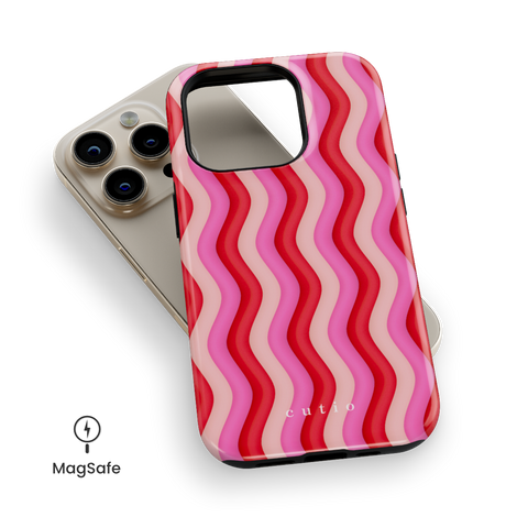 Unwind MagSafe phone case featuring bold Y2K-inspired groovy waves design in red, pink, and beige tones, top down view on iPhone