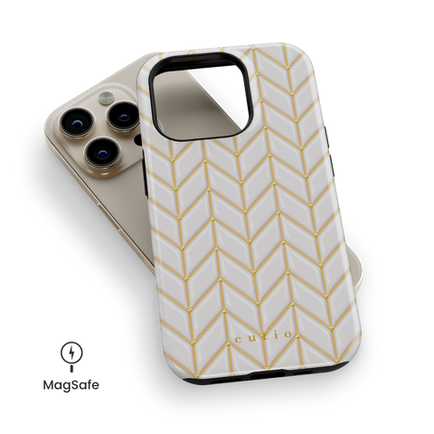 White Chevron MagSafe phone case featuring 3D-effect glossy white chevron pattern with gold trim details, top down view on iPhone