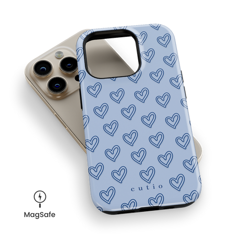 With Love - Dusty Blue MagSafe phone case featuring small hand-drawn heart pattern on a soft dusty blue background, top down view on iPhone