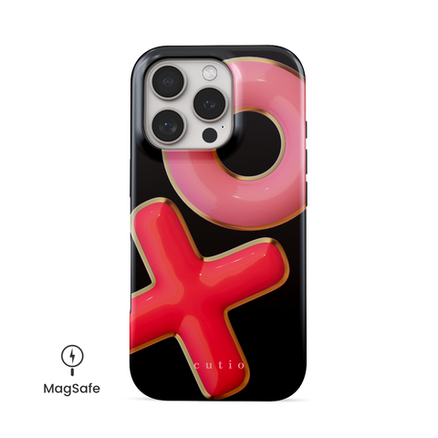 XO MagSafe phone case featuring 3D-effect XO design in bright red and pink with gold trim accents on a black background, front view on iPhone