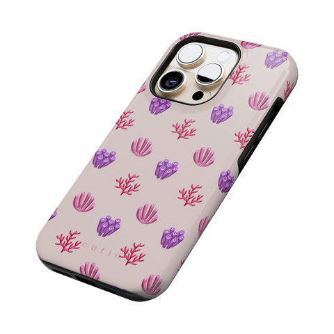 Blooming Coral tough phone case featuring glossy red, pink, and purple coral motifs scattered over a pale blush background, side view on iPhone
