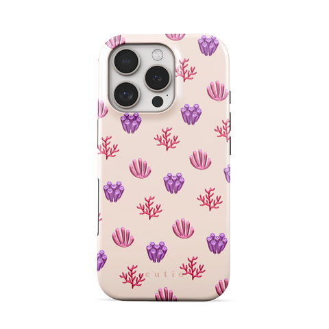 Blooming Coral tough phone case featuring glossy red, pink, and purple coral motifs scattered over a pale blush background, front view on iPhone