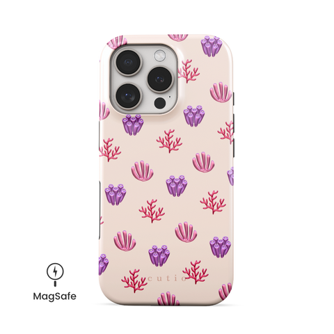 Blooming Coral MagSafe phone case featuring glossy red, pink, and purple coral motifs scattered over a pale blush background, front view on iPhone