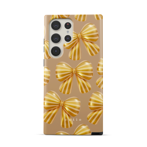 Bow Chic - Gold tough phone case featuring bold, eye-catching gold-striped bows on a muted gold backdrop, front view on Samsung Galaxy phone