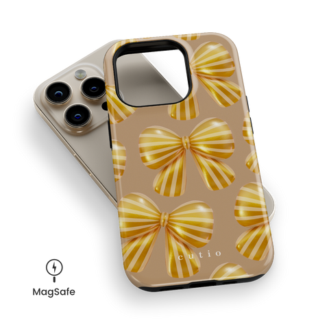 Bow Chic - Gold MagSafe phone case featuring bold, eye-catching gold-striped bows on a muted gold backdrop, top down view on iPhone