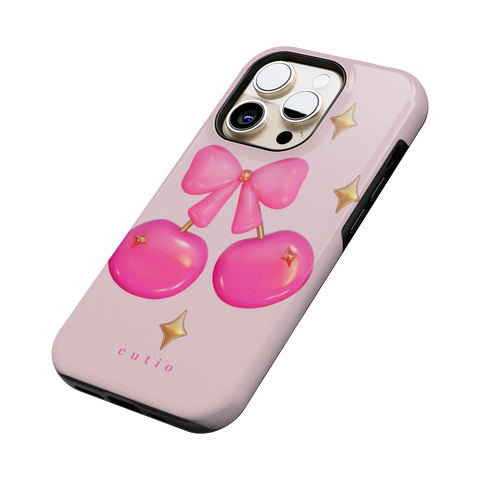 Cherry Pop tough phone case featuring glossy 3D-style hot pink cherries adorned with gold sparkles, tied together by a cute pink bow, side view on iPhone