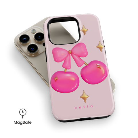 Cherry Pop MagSafe phone case featuring glossy 3D-style hot pink cherries adorned with gold sparkles, tied together by a cute pink bow, top down view on iPhone