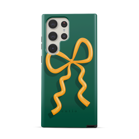 Present Moment - Green tough phone case featuring a glossy orange bow design on a rich green background, resembling a gift wrap ribbon, front view on Samsung Galaxy phone