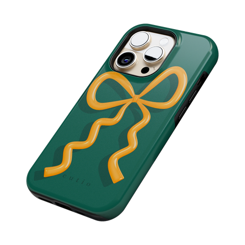 Present Moment - Green tough phone case featuring a glossy orange bow design on a rich green background, resembling a gift wrap ribbon, side view on iPhone