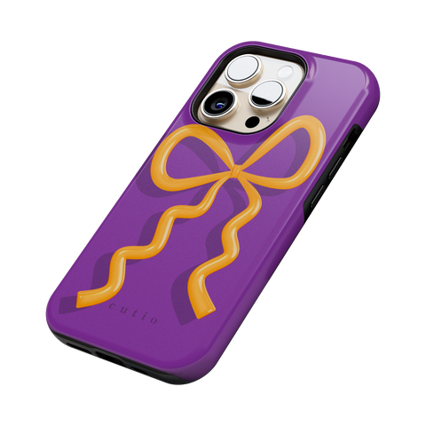 Present Moment - Purple tough phone case featuring a glossy orange bow design on a rich purple background, resembling a gift wrap ribbon, side view on iPhone