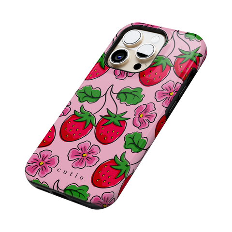 Strawberry Patch tough phone case featuring hand-drawn red strawberries with green leaves and pink flowers on a soft pink background, side view on iPhone