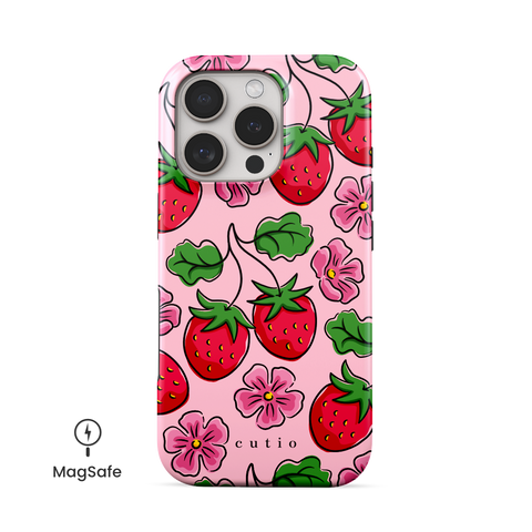 Strawberry Patch MagSafe phone case featuring hand-drawn red strawberries with green leaves and pink flowers on a soft pink background, front view on iPhone