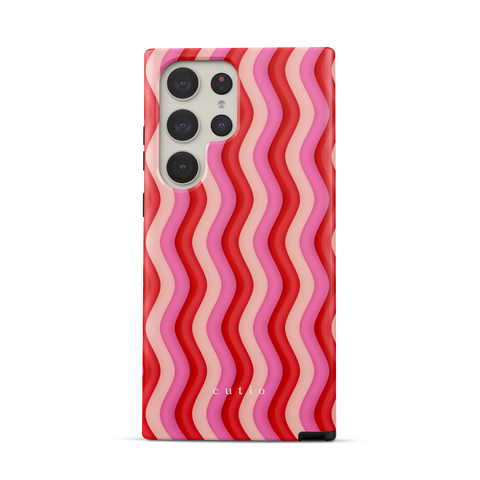 Unwind tough phone case featuring bold Y2K-inspired groovy waves design in red, pink, and beige tones, front view on Samsung Galaxy phone