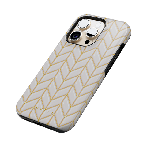 White Chevron tough phone case featuring 3D-effect glossy white chevron pattern with gold trim details, side view on iPhone