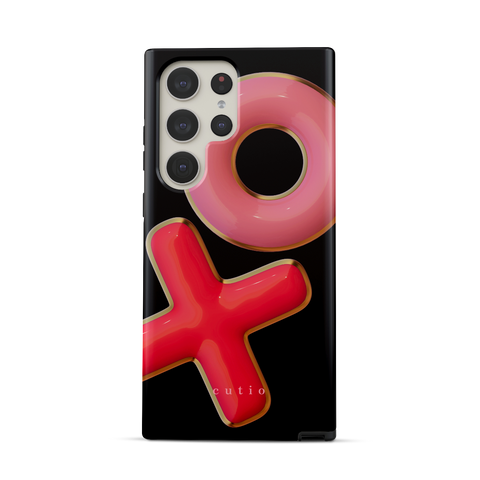 XO tough phone case featuring 3D-effect XO design in bright red and pink with gold trim accents on a black background, front view on Samsung Galaxy phone